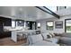 Bright, open kitchen with a large island, barstool seating, stainless steel appliances, and hardwood floors at 5358 Lions Paw St, Castle Rock, CO 80104