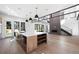 Open living area with kitchen island, tall ceilings and large windows providing natural light at 5358 Lions Paw St, Castle Rock, CO 80104