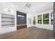 Bright living room with hardwood floors, built-in shelves, and modern lighting fixtures at 5358 Lions Paw St, Castle Rock, CO 80104