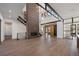 Spacious living area with fireplace, grand staircase, and open layout perfect for entertaining at 5358 Lions Paw St, Castle Rock, CO 80104