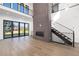 Bright living room features hardwood floors, a brick fireplace and access to outdoor space at 5358 Lions Paw St, Castle Rock, CO 80104
