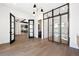 Open layout showcasing hardwood floors, stylish lighting, and view of the kitchen and bath at 5358 Lions Paw St, Castle Rock, CO 80104
