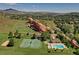 Aerial view of home with tennis courts, pool, and stunning mountain views, ideal for sports and outdoor activities at 11886 Elk Head Range Rd, Littleton, CO 80127