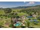 Aerial view of community with pool, tennis courts, parks, mountain views, and lush landscaping at 11886 Elk Head Range Rd, Littleton, CO 80127