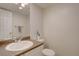 Bright bathroom featuring a single sink vanity with countertop and a neutral color palette at 11886 Elk Head Range Rd, Littleton, CO 80127