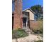 Charming two-story home with brick chimney, brick fence, colorful flower bed, and inviting front entrance at 11886 Elk Head Range Rd, Littleton, CO 80127