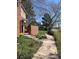 Well-maintained front yard with a sidewalk, brick fence, garden bed, and view of the surrounding neighborhood at 11886 Elk Head Range Rd, Littleton, CO 80127