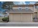 Two-car garage with paved driveway and well-maintained landscaping enhancing the exterior appeal at 11886 Elk Head Range Rd, Littleton, CO 80127