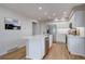 Bright kitchen with white cabinets, stainless appliances, and spacious island at 11886 Elk Head Range Rd, Littleton, CO 80127