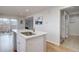Spacious kitchen featuring an island with an undermount sink and access to the laundry room at 11886 Elk Head Range Rd, Littleton, CO 80127