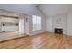 Open living room with hardwood floors, fireplace, and bright, airy atmosphere at 11886 Elk Head Range Rd, Littleton, CO 80127