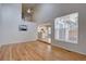 Bright living room featuring hardwood floors, a fireplace, and connection to the kitchen at 11886 Elk Head Range Rd, Littleton, CO 80127