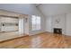 Cozy living room with hardwood floors, a fireplace, and lots of natural light at 11886 Elk Head Range Rd, Littleton, CO 80127