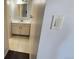 Hallway view of the bathroom featuring tile floors, sink vanity and an interior mirror at 2281 S Vaughn Way # 118A, Aurora, CO 80014