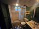 Bathroom features a shower-tub combo, patterned floor tiles, and bright wallpaper at 912 E 6Th Ave, Broomfield, CO 80020