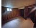 Bedroom features wood paneling, carpet flooring, and a window letting in natural light at 912 E 6Th Ave, Broomfield, CO 80020