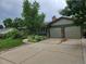 Charming single-story home with a two-car garage and lush landscaping at 912 E 6Th Ave, Broomfield, CO 80020
