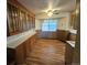 Eat-in kitchen with wooden cabinets and laminate floors, perfect for Gathering meals at 912 E 6Th Ave, Broomfield, CO 80020