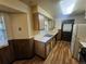 Classic kitchen features wood cabinets, stainless steel sink, and wood-look flooring at 912 E 6Th Ave, Broomfield, CO 80020