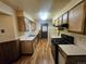 Functional kitchen featuring wooden cabinets, modern appliances and linoleum flooring at 912 E 6Th Ave, Broomfield, CO 80020