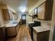 Functional kitchen featuring wooden cabinets, modern appliances and linoleum flooring at 912 E 6Th Ave, Broomfield, CO 80020
