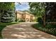 Luxury two-story home with circular driveway and manicured landscaping at 2 Cherry Hills Farm Dr, Cherry Hills Village, CO 80113