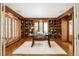 Spacious library with built-in bookshelves and hardwood floors at 2 Cherry Hills Farm Dr, Cherry Hills Village, CO 80113