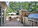 Outdoor kitchen with stainless steel appliances and dining area at 2 Cherry Hills Farm Dr, Cherry Hills Village, CO 80113