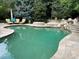 Inviting freeform swimming pool with flagstone decking at 2 Cherry Hills Farm Dr, Cherry Hills Village, CO 80113