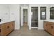 Modern bathroom with double vanity, tile floors, and glass-enclosed shower at 5629 Farrier Pt, Castle Rock, CO 80104