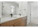 Bathroom featuring double vanity with modern fixtures and a large mirror at 5629 Farrier Pt, Castle Rock, CO 80104