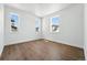 Well-lit bedroom with hardwood floors and multiple windows offering natural light at 5629 Farrier Pt, Castle Rock, CO 80104