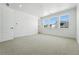 Bright bedroom with carpet, white walls, and ample natural light from windows at 5629 Farrier Pt, Castle Rock, CO 80104