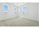 Sunlit bedroom with plush carpet and multiple windows showcasing neighborhood views at 5629 Farrier Pt, Castle Rock, CO 80104