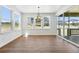 Bright dining area featuring wood floors, large windows, and modern chandelier at 5629 Farrier Pt, Castle Rock, CO 80104