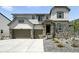 Charming two-story home featuring a stone facade, three-car garage, and well-maintained landscaping at 5629 Farrier Pt, Castle Rock, CO 80104