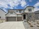 Charming two-story home with stone accents, a three-car garage, and professionally landscaped front yard at 5629 Farrier Pt, Castle Rock, CO 80104
