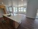 Spacious kitchen featuring a large island with quartz countertops, modern appliances, and adjacent dining area at 5629 Farrier Pt, Castle Rock, CO 80104