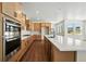 Spacious, modern kitchen with stainless steel appliances, kitchen island, and tile backsplash at 5629 Farrier Pt, Castle Rock, CO 80104