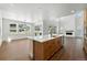 Bright, modern kitchen with stainless steel appliances, a large island, and hardwood floors at 5629 Farrier Pt, Castle Rock, CO 80104