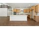 Modern kitchen with stainless steel appliances, a large island, and hardwood floors at 5629 Farrier Pt, Castle Rock, CO 80104