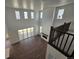 Expansive living room with tall ceilings, fireplace, and a view from the second-floor landing at 5629 Farrier Pt, Castle Rock, CO 80104