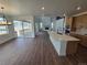 Open-concept living space with a modern kitchen island, high ceilings, and seamless flow to outdoor patio at 5629 Farrier Pt, Castle Rock, CO 80104