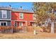 View of the back of the house showing a spacious yard with a wooden fence for privacy at 1011 Milo Cir # A, Lafayette, CO 80026