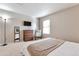 Bright bedroom featuring a large window, TV, comfortable chair, and a dresser at 1011 Milo Cir # A, Lafayette, CO 80026