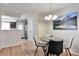 Chic dining area with a modern table and chairs, stylish lighting, and scenic artwork at 1011 Milo Cir # A, Lafayette, CO 80026
