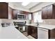 Well-equipped kitchen with stainless steel appliances, dark cabinetry, and ample counter space at 1011 Milo Cir # A, Lafayette, CO 80026