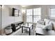 Relaxing living room with a large window, TV, comfy sofa, and a minimalist decor at 1011 Milo Cir # A, Lafayette, CO 80026