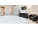 Comfortable main bedroom with a dresser, stylish black chair, and view of ensuite bath at 1011 Milo Cir # A, Lafayette, CO 80026