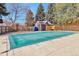 Covered swimming pool surrounded by mature trees, a shed, and fenced-in yard at 1011 Milo Cir # A, Lafayette, CO 80026